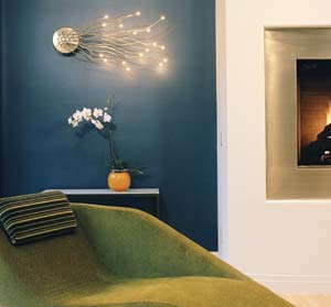 Zaneen Lighting's playful Medusa sconce is energy efficient—in three years the owners have not had to replace a light bulb. The chaise is a favorite place to read and enjoy the fireplace.